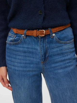 women wearing blue jeans and a brown suede belt