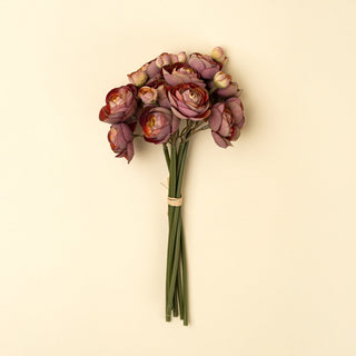 Bouquet of artificial purple roses on a beige background