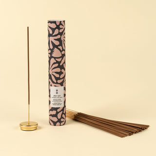 Incense stick set with patterned packaging on a beige background