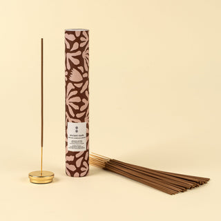 Incense stick set with patterned packaging on a beige background