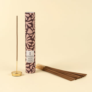 Incense stick set with patterned packaging on a beige background