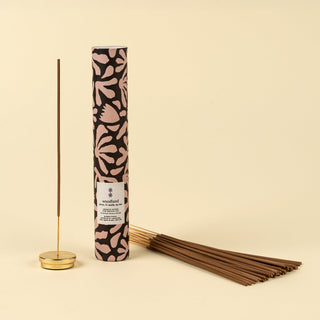 Incense stick set with patterned packaging on a beige background