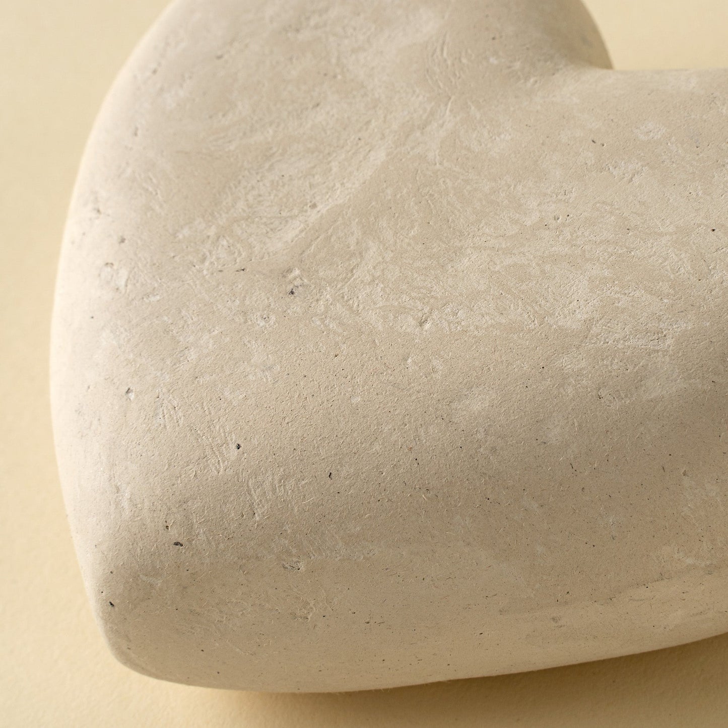 Close-up of a beige stone object on a beige background