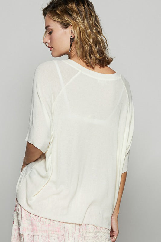 Woman wearing a white blouse with a plain background