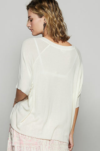 Woman wearing a white blouse with a plain background