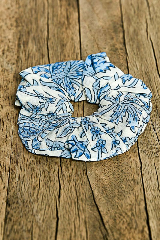 Blue floral scrunchie on a wooden surface