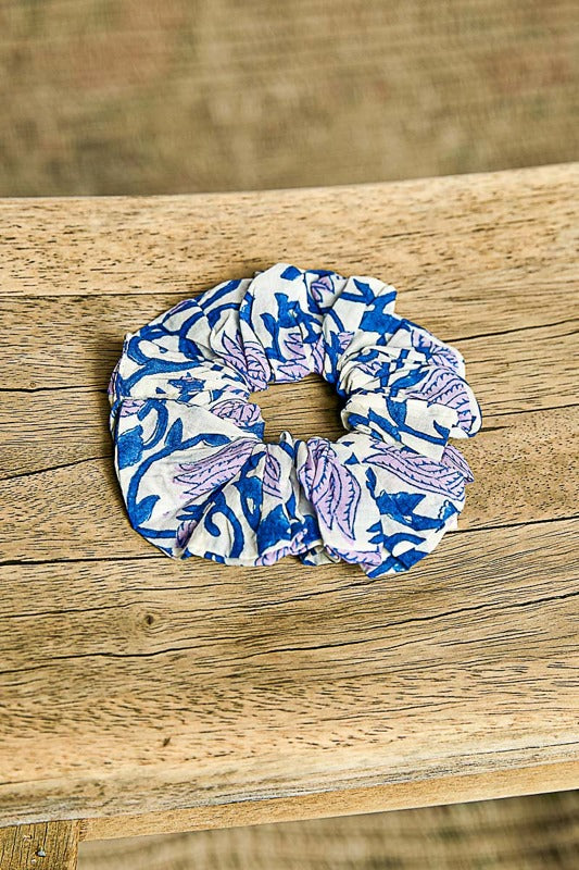 Blue and white patterned scrunchie on a wooden surface