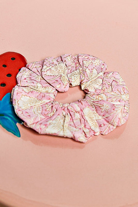 Pink floral scrunchie on a pink background