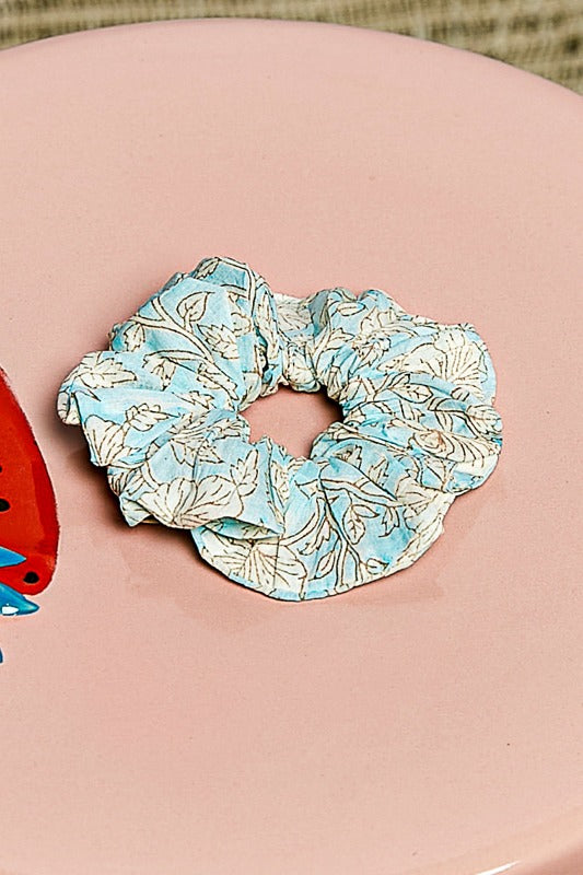 Floral patterned scrunchie on a pink surface