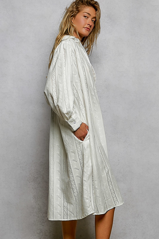 Woman wearing a long white dress against a plain background