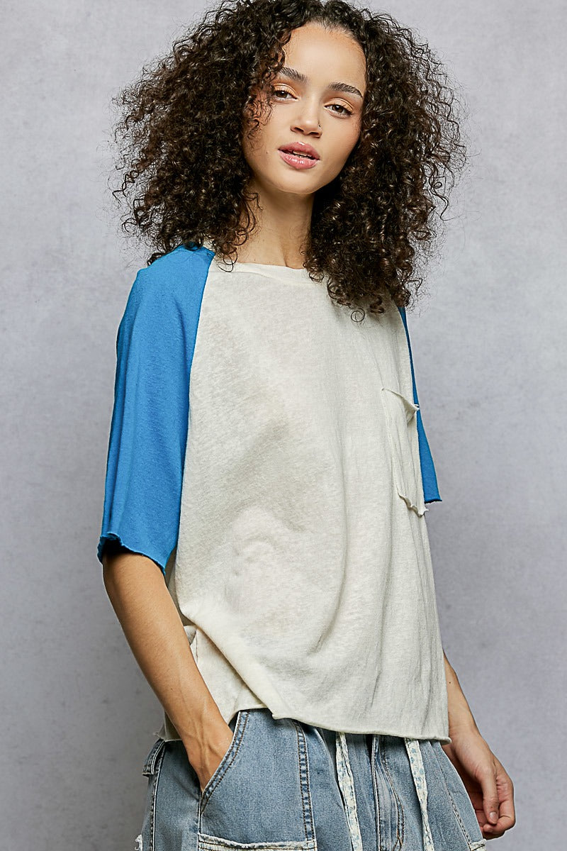 Woman wearing a blue and white top with a gray background