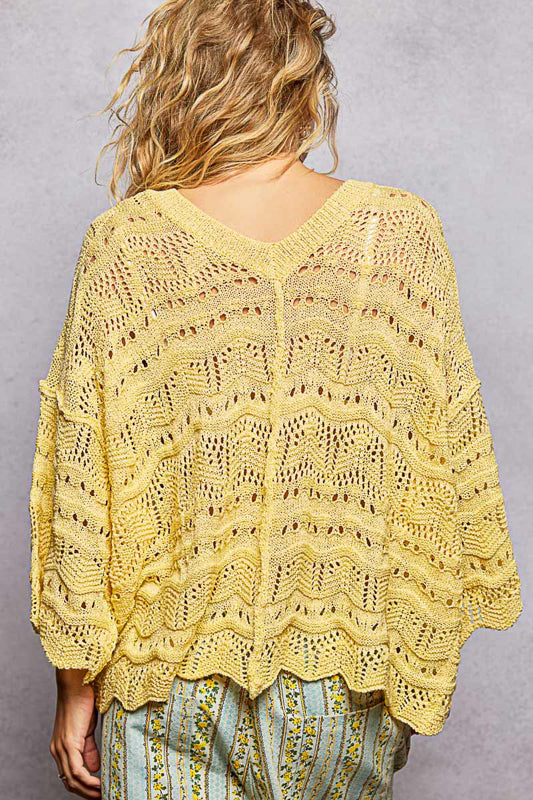 Yellow lace top worn by a person, with a blurred background