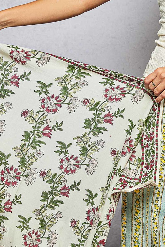 Floral patterned fabric being held with a neutral background
