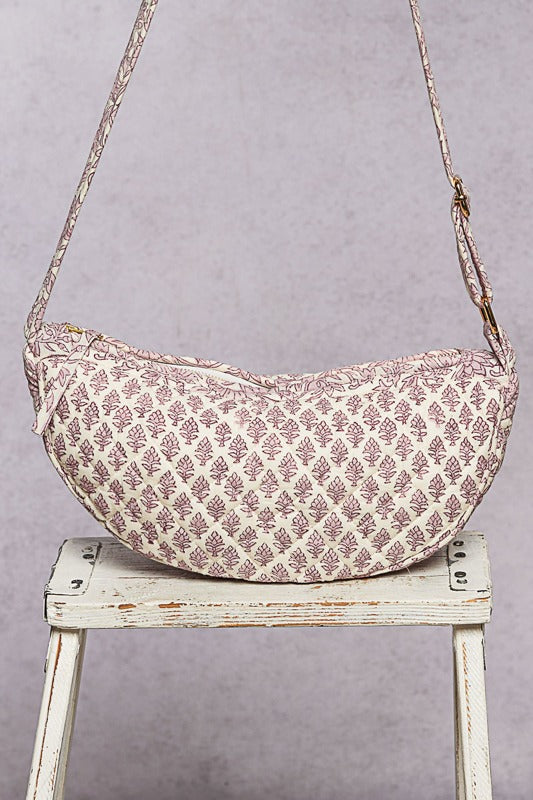 A quilted bag sitting on a stool