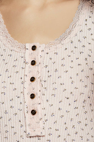 Close-up of a floral-patterned top with button details