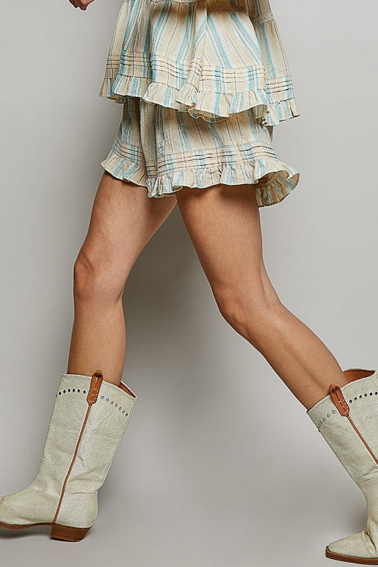 Person wearing a plaid skirt and white boots with brown soles on a plain background