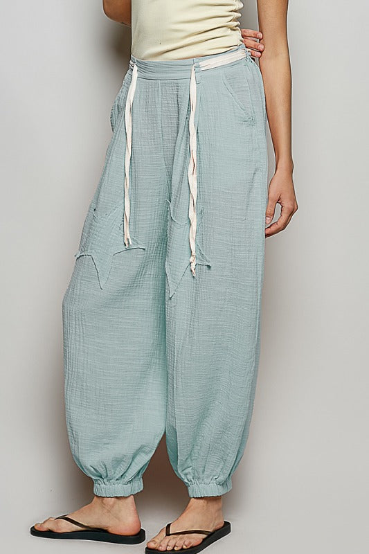Light blue checkered pants with drawstring waist on a plain background