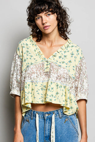 Women wearing a yellow floral and lace design top. 
