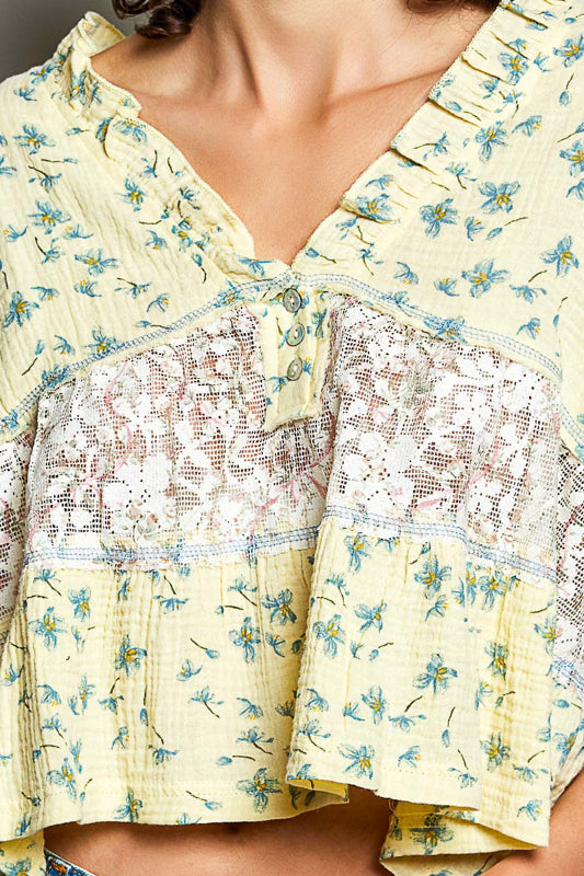 Women wearing a yellow floral and lace design top. 