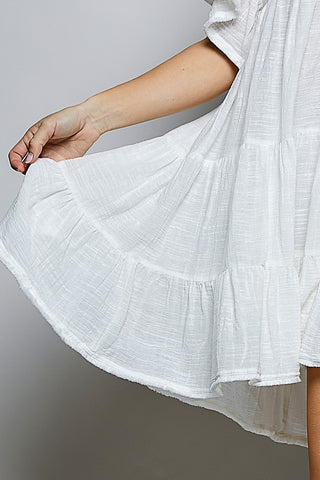 White dress with a gray background