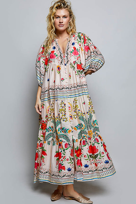 Woman wearing a colorful floral dress on a gray background