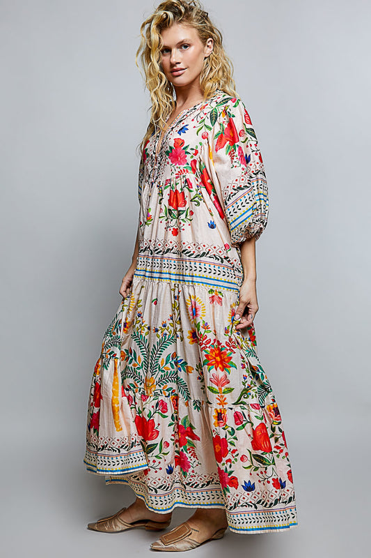 Woman wearing a colorful floral dress on a gray background