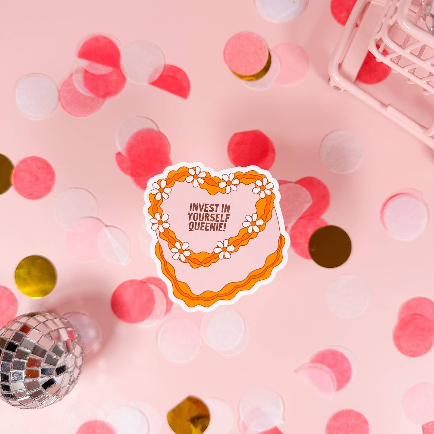Motivational sticker with 'Invest in Yourself Queenie!' text on a pink background with confetti and disco ball.