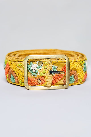 A yellow woven belt with colorful floral embroidery in orange, green, and white, featuring a gold-tone metal buckle.