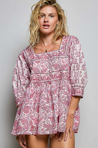 Women wearing a pink floral top against a neutral background.