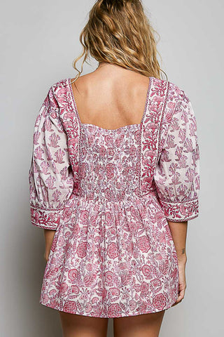 Women wearing a pink floral top against a neutral background.