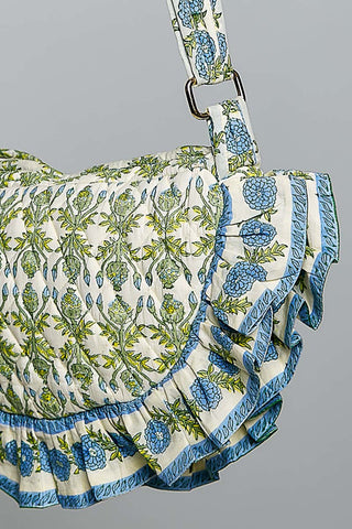 Floral patterned bag with ruffled edge on a gray background