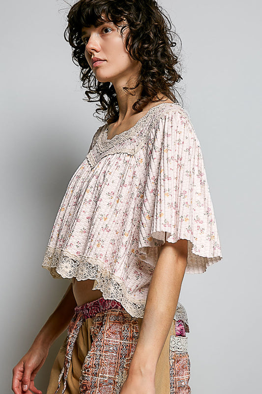 Woman wearing a floral blouse with a plain background