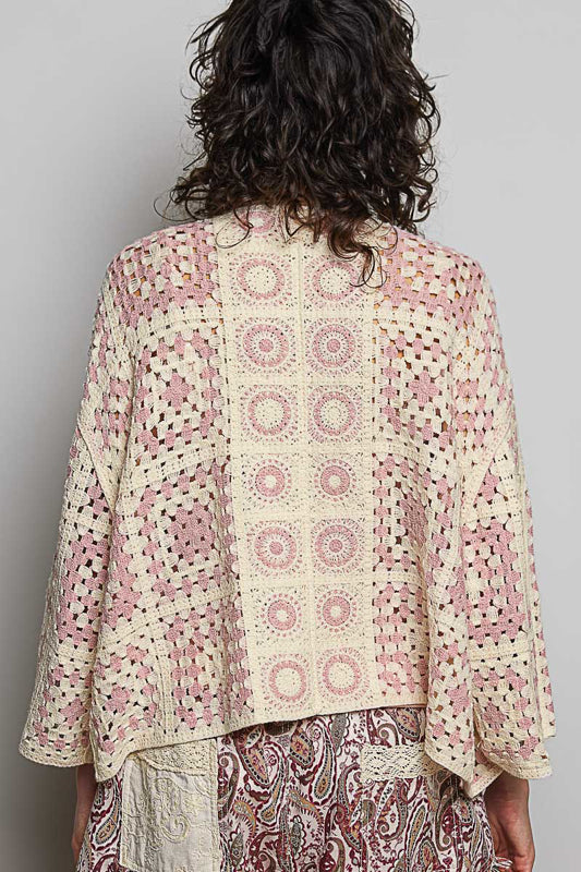 Person wearing a patterned outfit with a neutral background