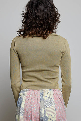 women wearing a ribbed long sleeve against a neutral background. 