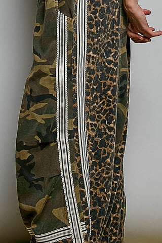 Camo and leopard print fabric with white stripes on a neutral background