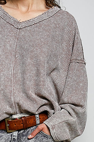 Person wearing a plaid shirt with a plain background