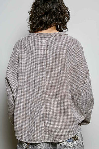 Person wearing a checkered shirt with a plain background
