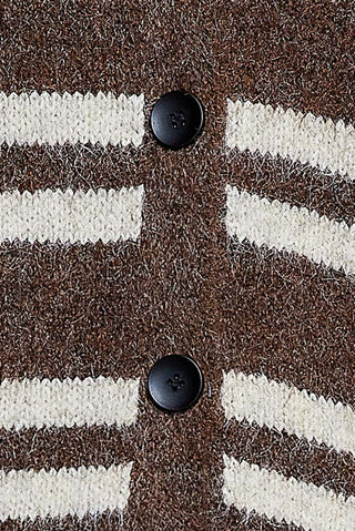 Close-up of a knit cardigan with horizontal brown and cream stripes and two black buttons.