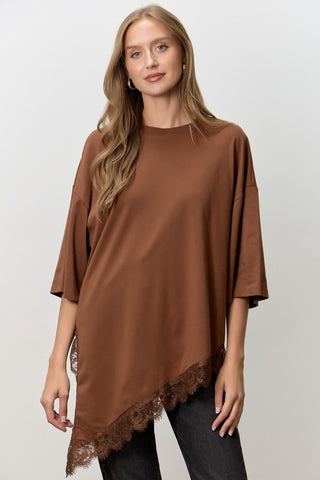 Women wearing a brown t shirt with Lace Trim against a neutral background. 