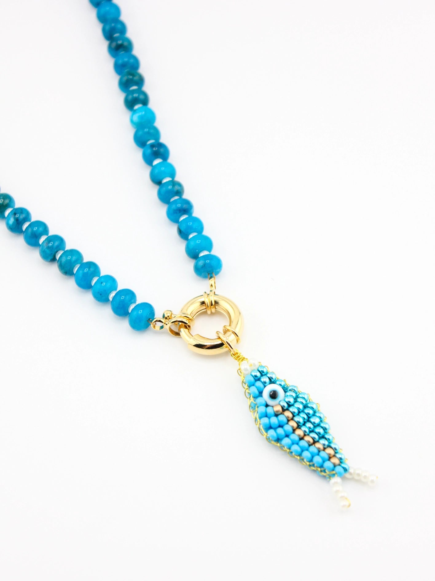 Turquoise beaded necklace with a gold clasp on a white background