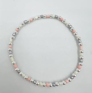 Necklace with multicolored beads on a light gray background