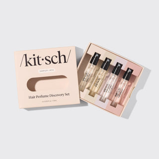 Kitsch hair perfume discovery set with four small bottles in a box on a light gray background
