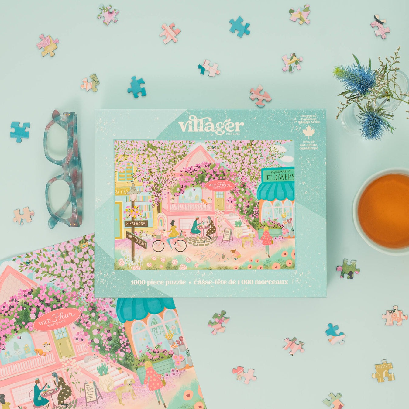 Villager puzzle box with a floral village design on a light blue background with puzzle pieces and a teacup.