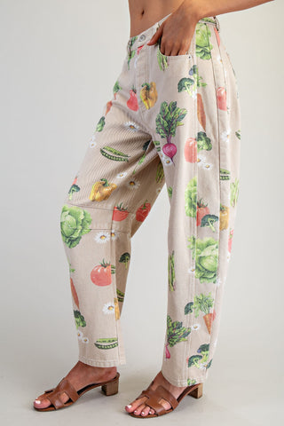 Pants with a colorful fruit and vegetable pattern on a plain background