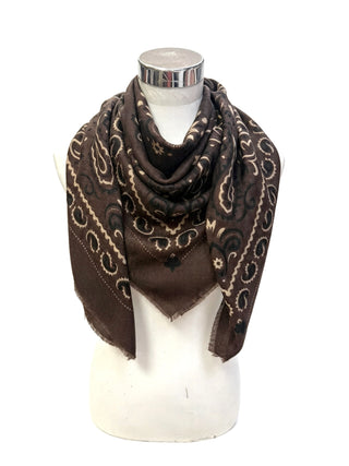 A brown bandana scarf with a black and white paisley pattern, draped on a white mannequin torso against a white background.