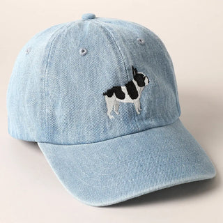Light blue denim cap with a dog illustration on a beige background