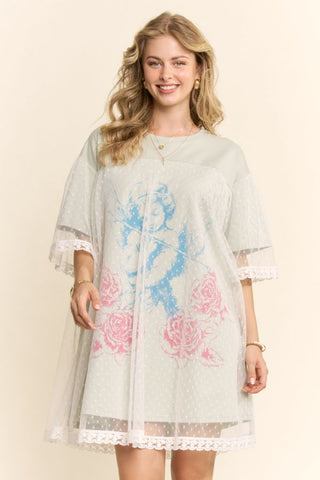 Women modelling a sage green mini dress with a lace overlay against a neutral photo backdrop.