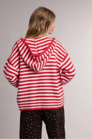 Women wearing a striped hoodie against a neutral background.