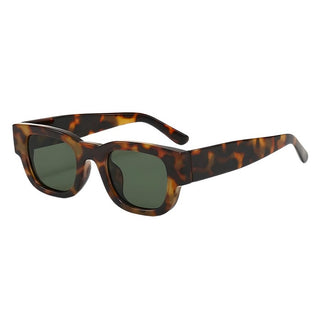 a pair of tortoise sunglasses on a white background