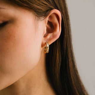 women modelling a pair of diamond gold hoop earrings.